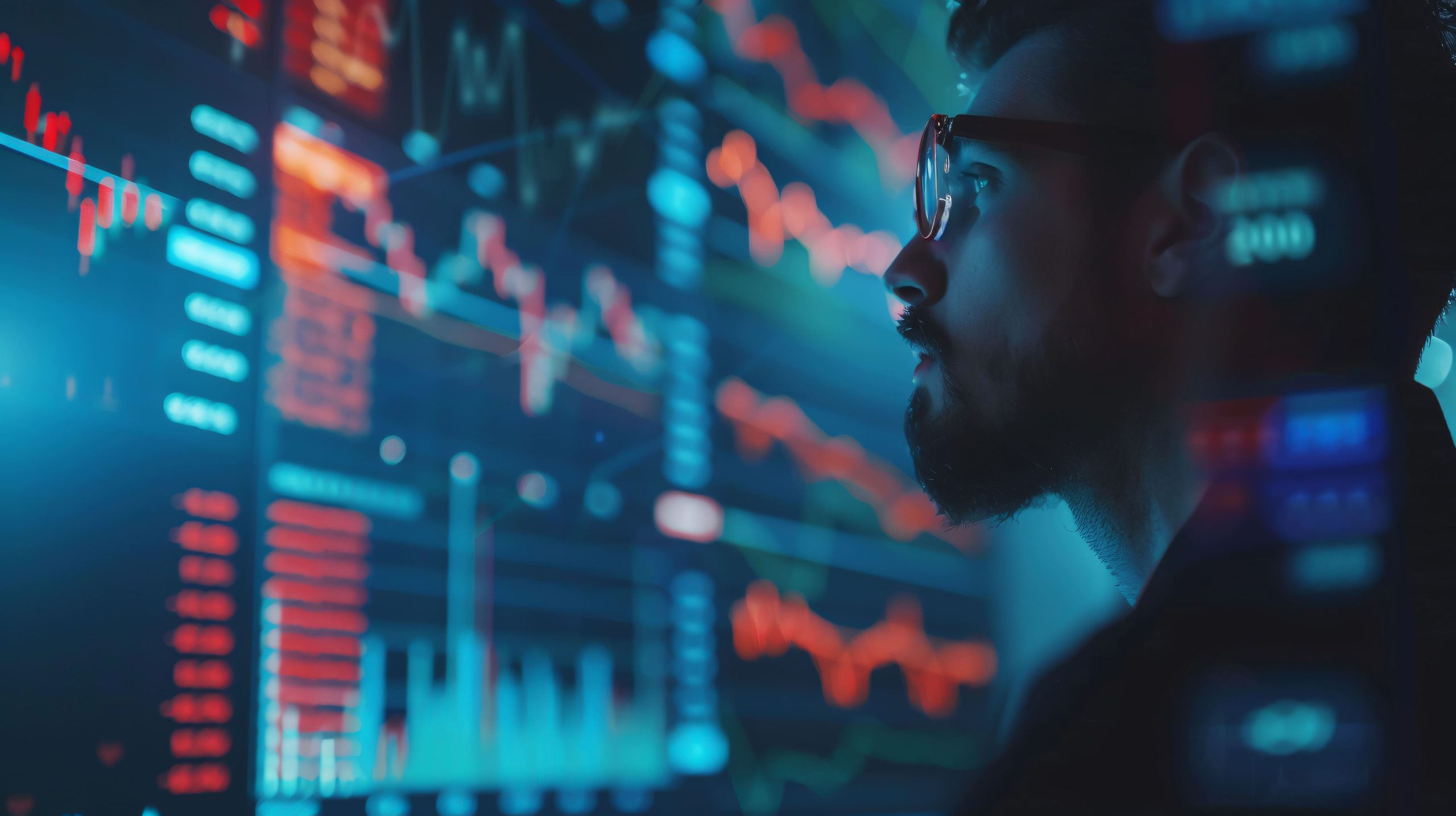 Homem analisando gráficos financeiros em uma tela, simbolizando estratégias de perfil de investidor.